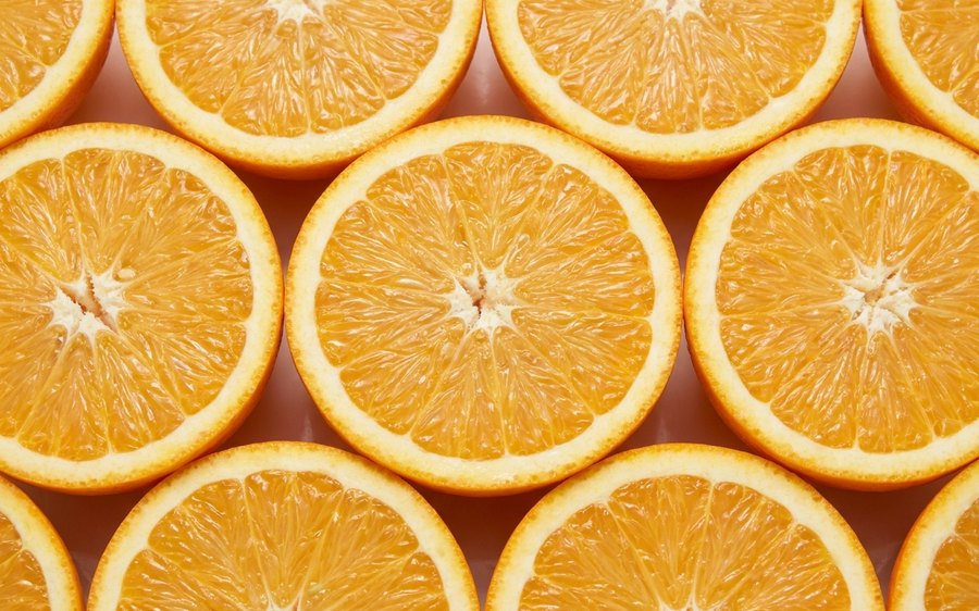 Halved oranges packed edge to edge