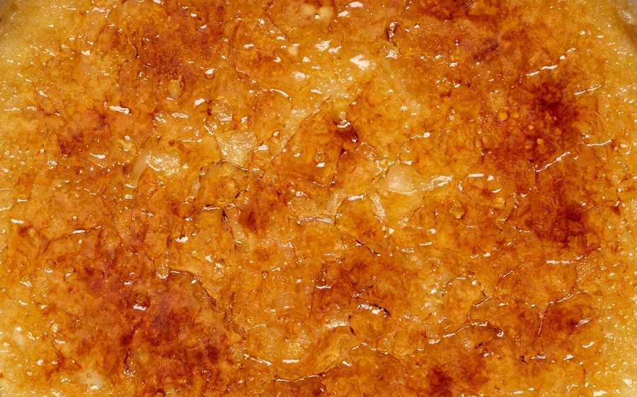 Caramelised crème brûlée sugar crust filling the frame